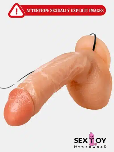 A close-up photo of a multi-speed realistic vibrating dildo, featuring lifelike textures and adjustable vibration settings.