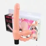 A Strapless Dildo Vibration item placed next to its charging cable on a wooden surface.