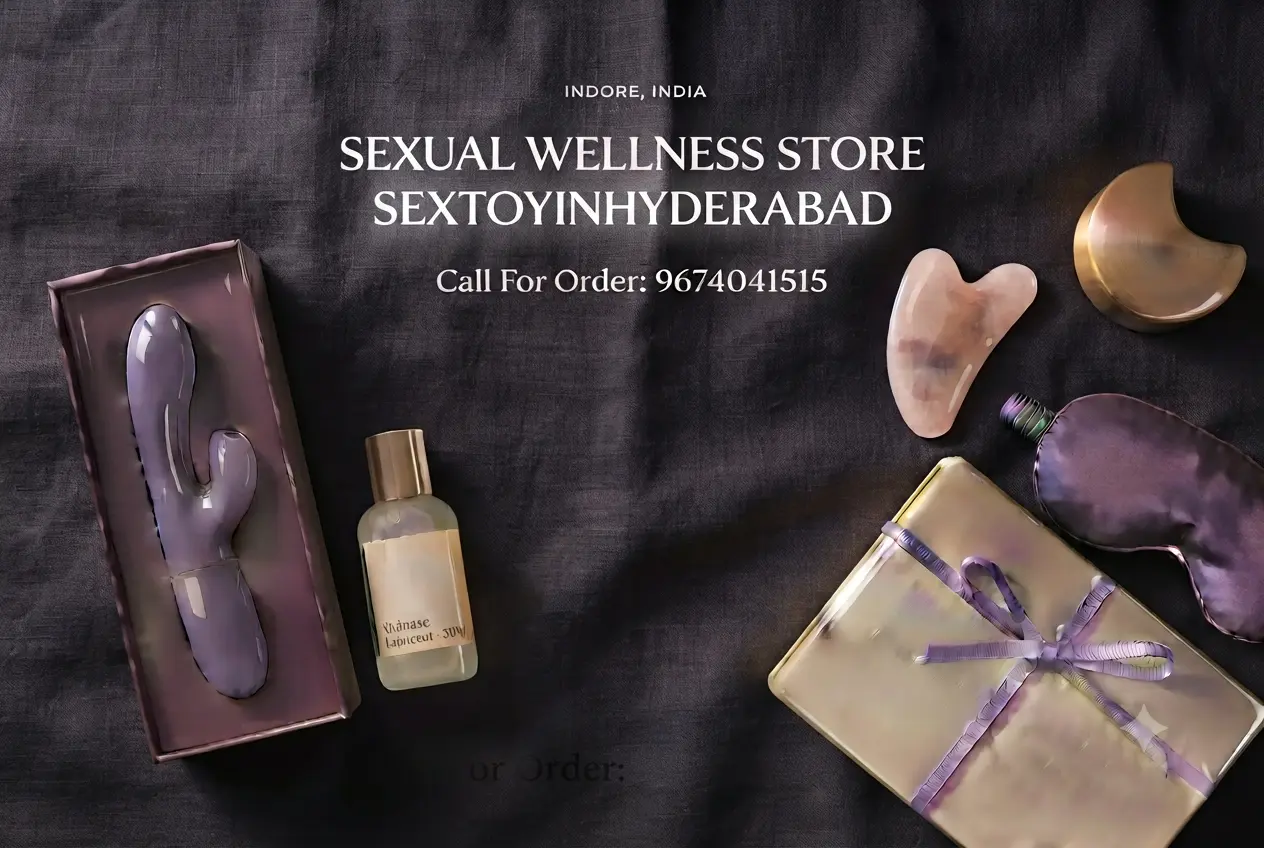 A high-end flat lay featuring a purple personal massager in its packaging, a bottle of lubricant, rose quartz tools, a satin eye mask, and gold accessories on a dark fabric background, representing a confidential store for sex toys in Indore.