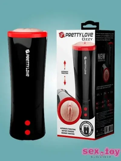 An Automatic Thrusting Male Masturbator placed next to a USB charger on a desk.